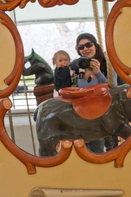 Ryan and Colin playing on a sculpture at the zoo laughing