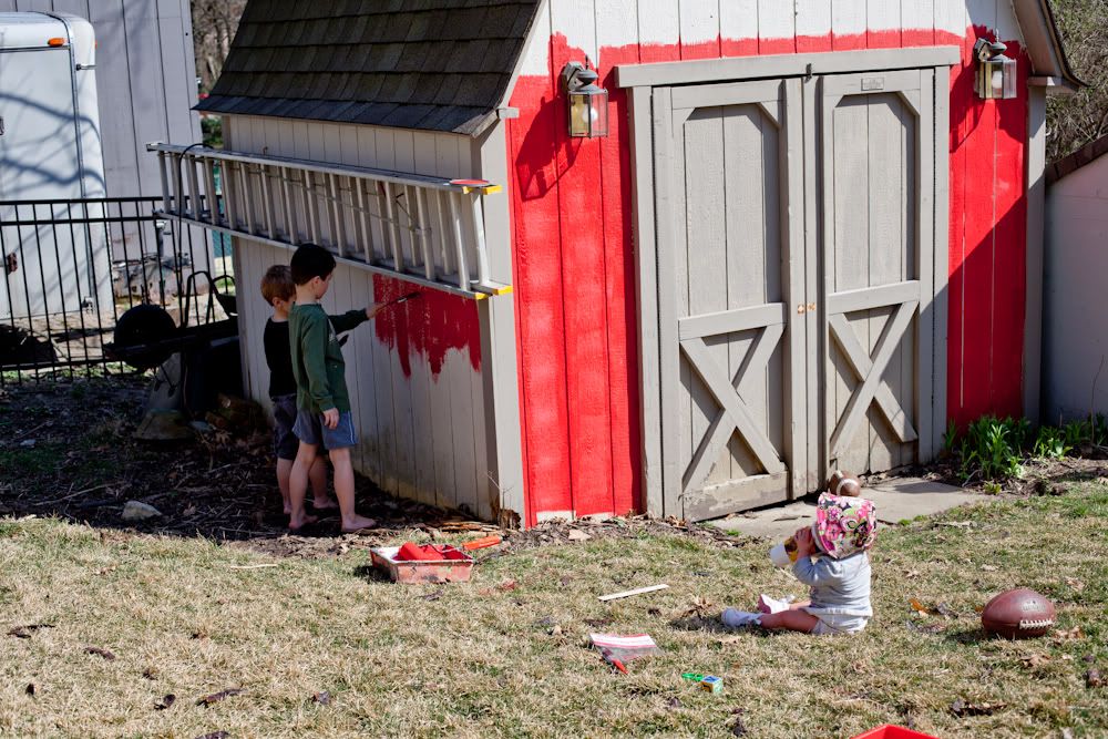 The boys and Grace help paint the shed barn red