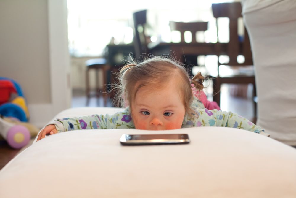 Special needs child receiving therapy to crawl from Mother